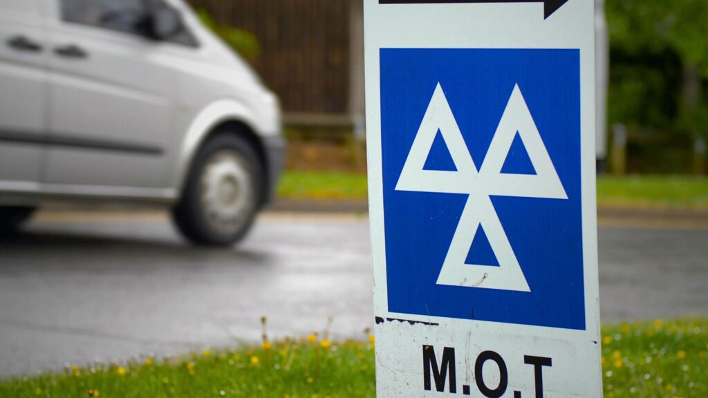 A blue and white sign displaying 'MOT Test'