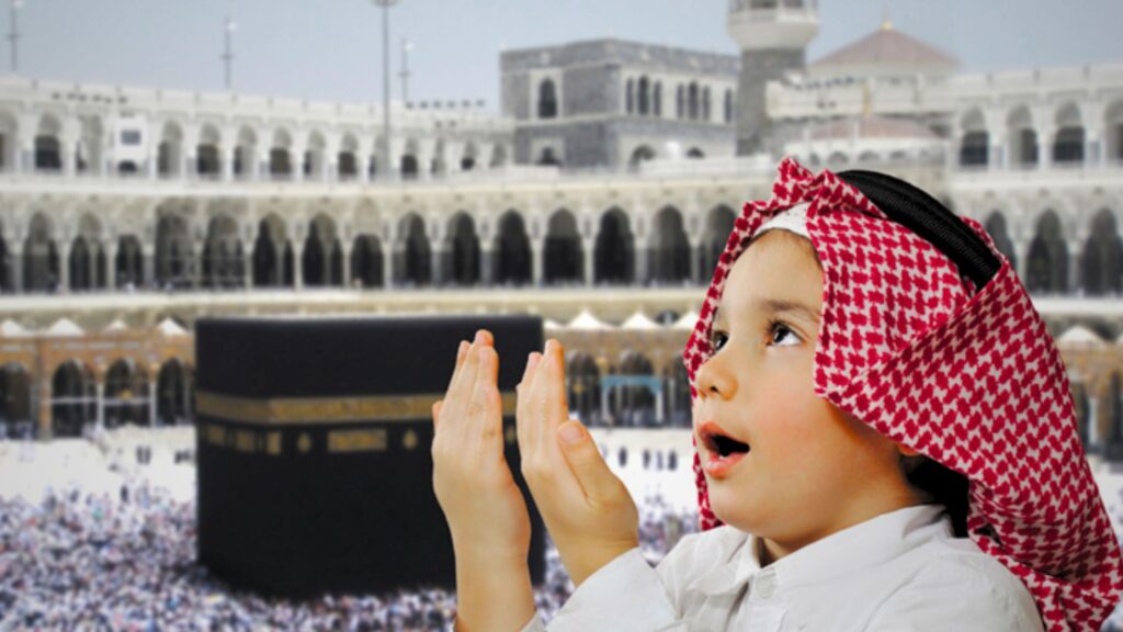 A child in traditional muslim attire praying in front of the Kaaba, the holiest site in Islam