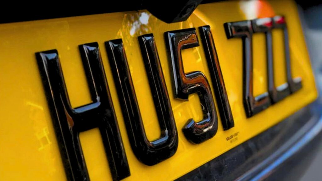 A close-up of one yellow 4d number plates