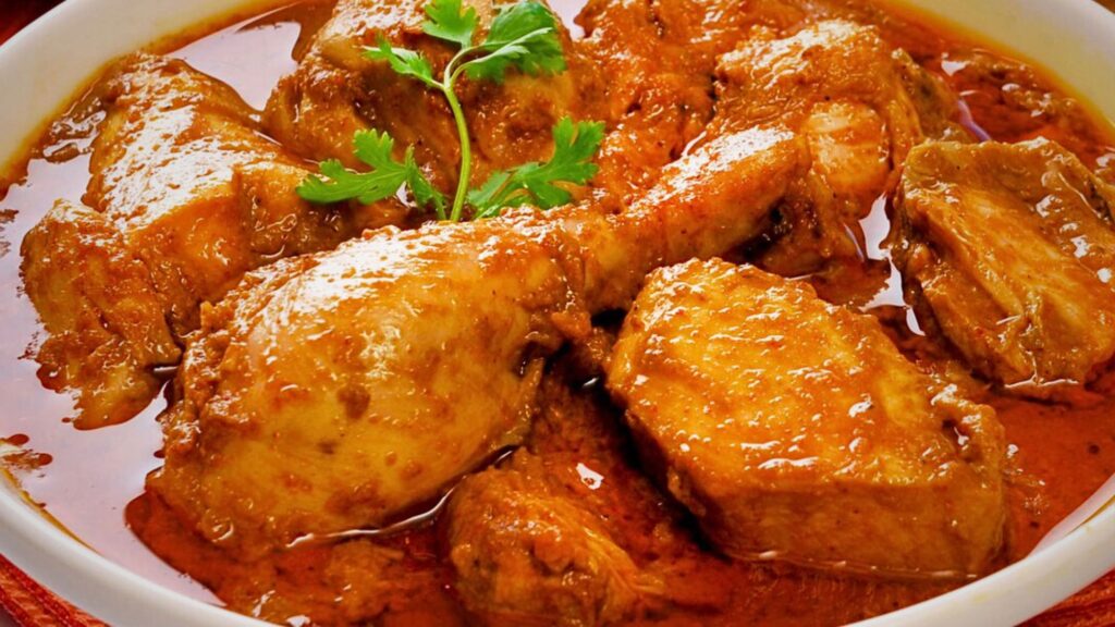 A delicious chicken curry dish with masala recipes, aromatic spices and fresh parsley garnish