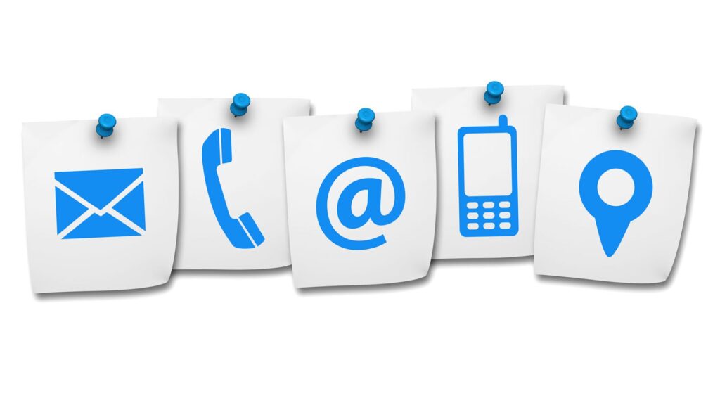 Several paper notes with phone and email icons, representing contact page information for improved SEO ranking
