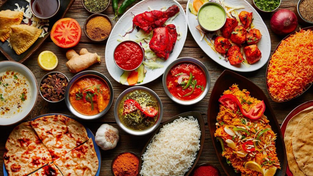 Various types of indian food on a table, showcasing the rich flavors and vibrant colors of masala recipes